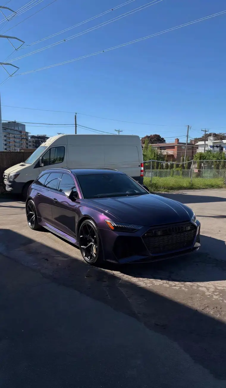 Purple Audi RS6 Avant front three-quarter view shining in the sun