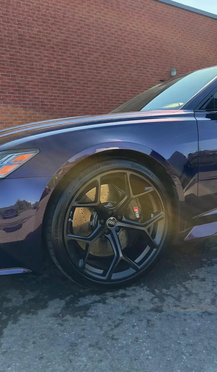 Audi RS6 black wheel with gold brake rotors, detailed to spotless