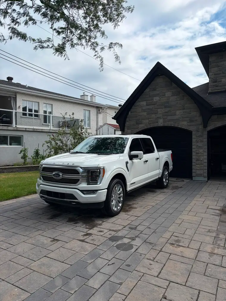 White Ford F-150 Limited detailed on a paver driveway in Montreal