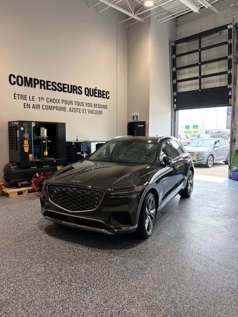 Dark green Genesis GV70 detailed inside a commercial shop