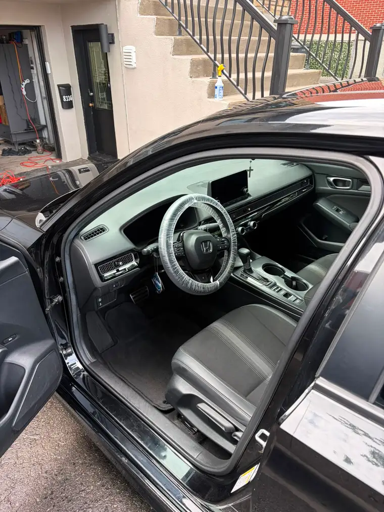 Honda Civic interior deep-cleaned, steering wheel wrapped for delivery