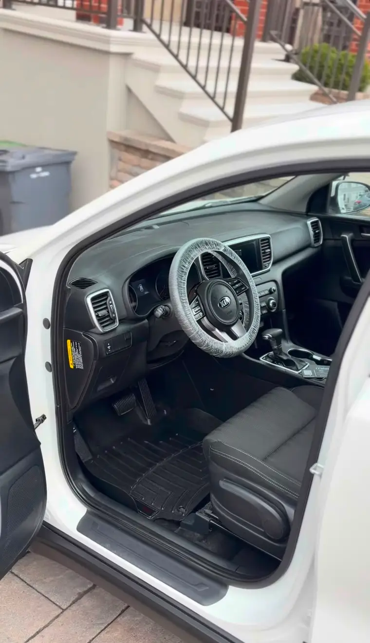 White Kia SUV interior deep-cleaned with shampooed floor mats