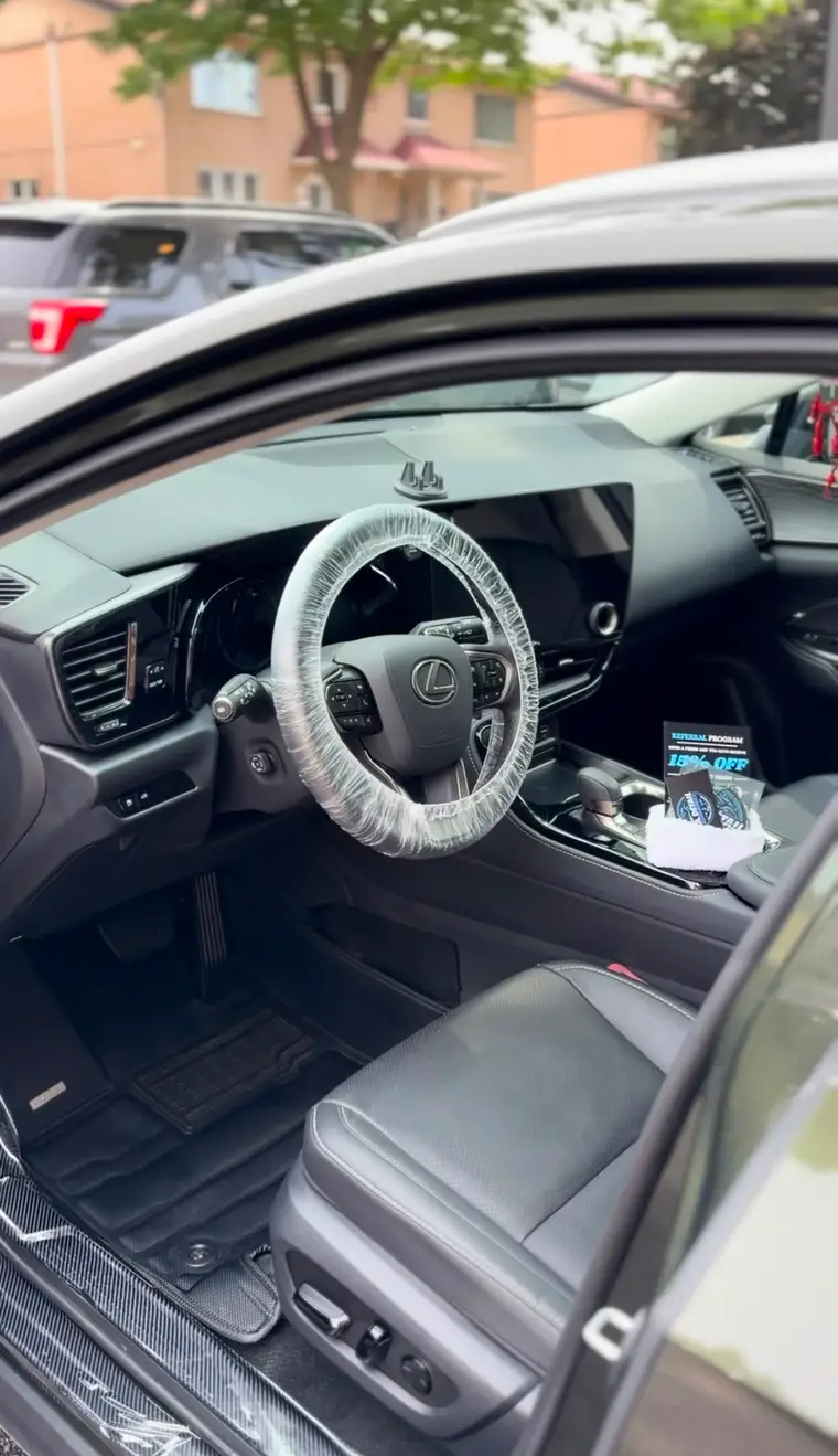 Black Lexus interior steam-cleaned, steering wheel wrapped for delivery