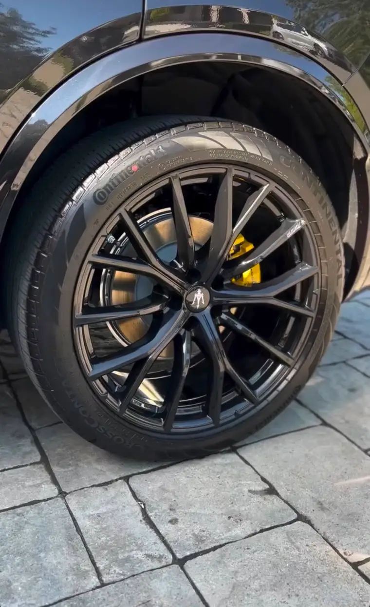 Black Maserati wheel with yellow calipers detailed to spotless