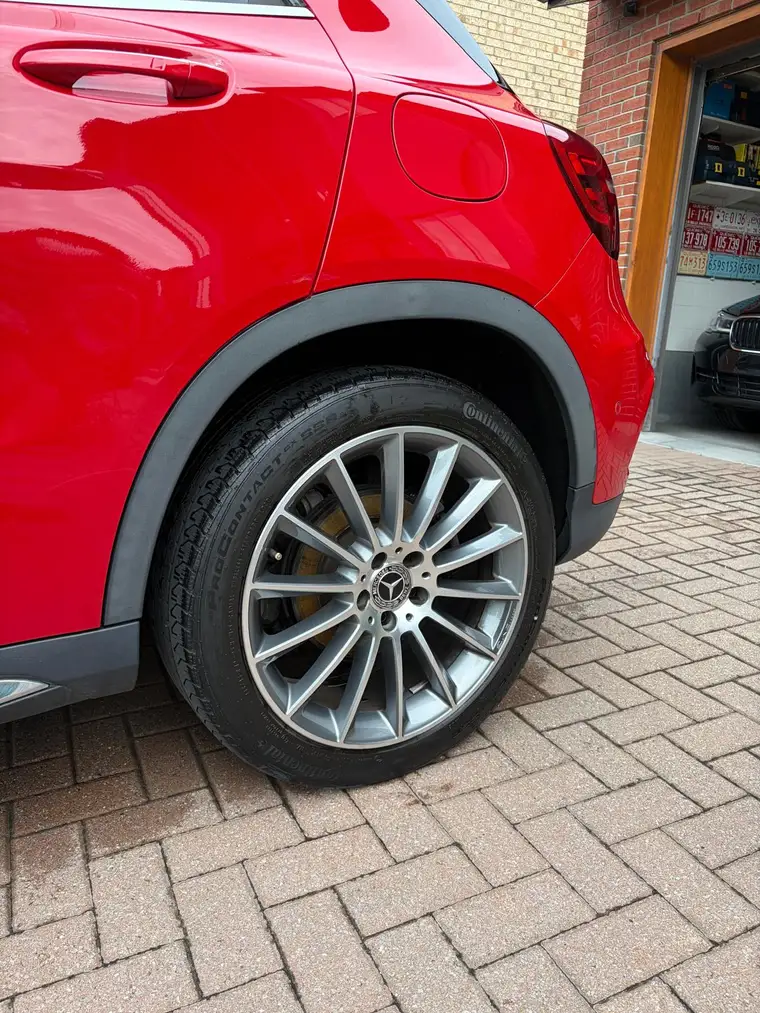 Red Mercedes GLA rear quarter with polished AMG multi-spoke wheel