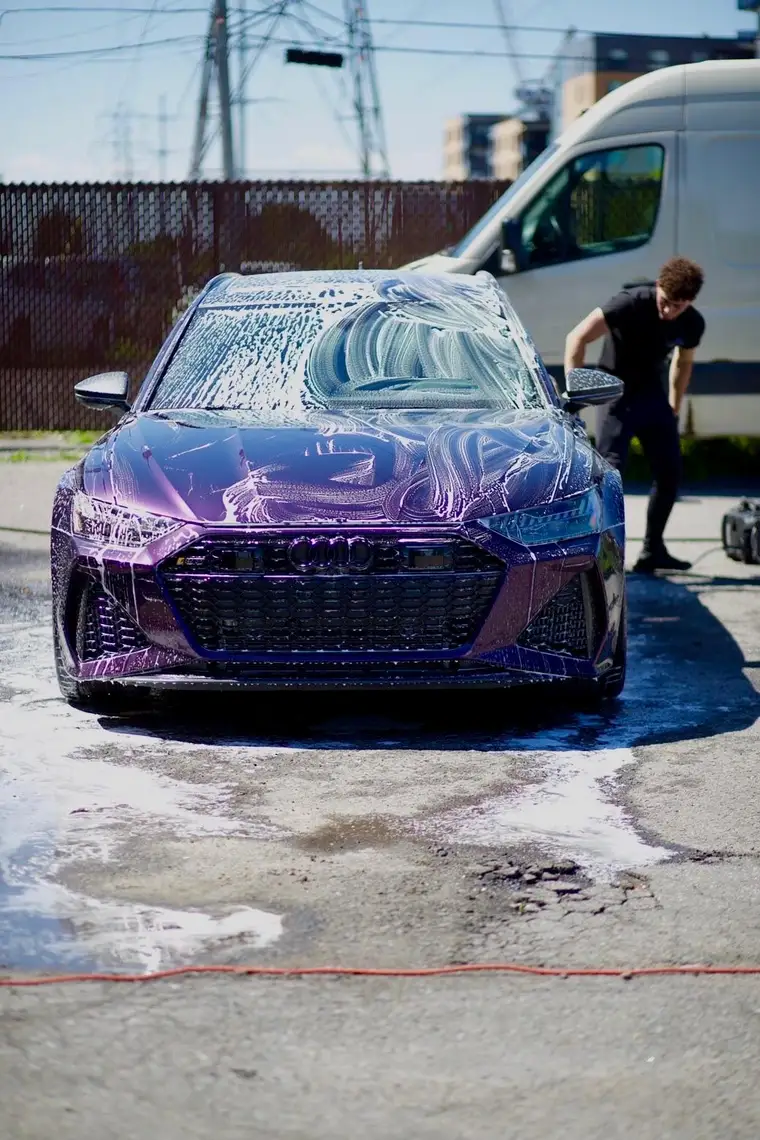 Audi RS6 covered in thick snow foam during a two-bucket paint-safe wash
