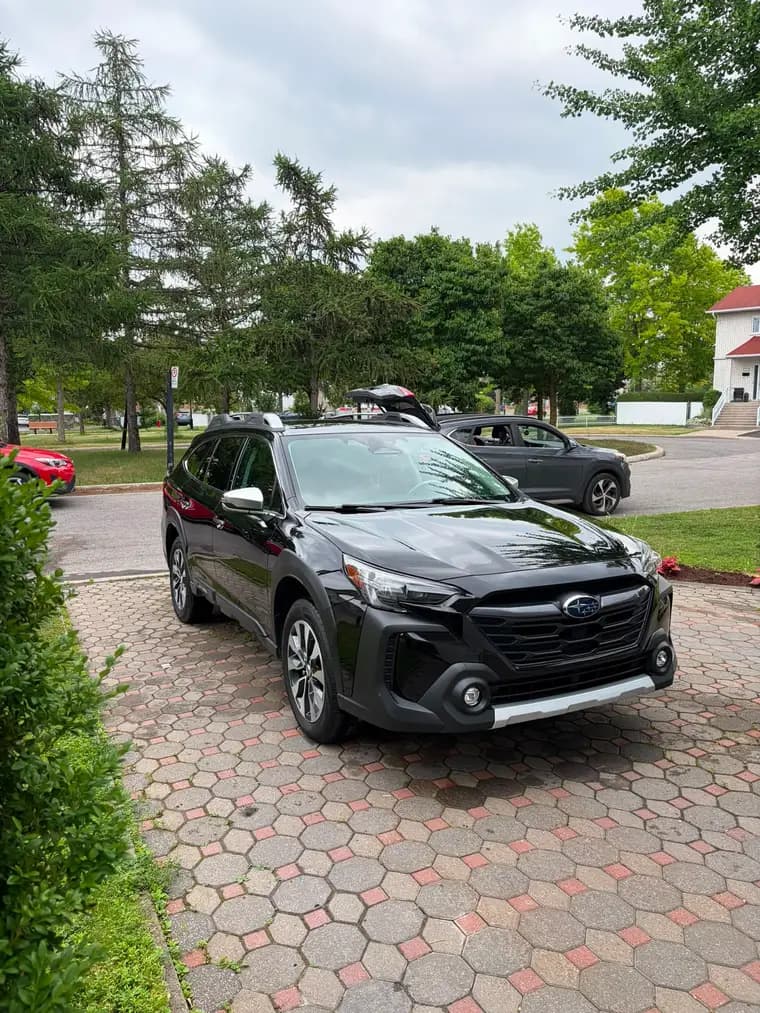 Black Subaru Outback detailed on a paver driveway in Montreal