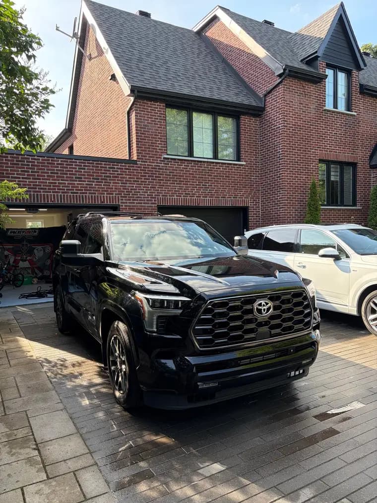 Black Toyota Sequoia gleaming after a full detail in a Montreal driveway
